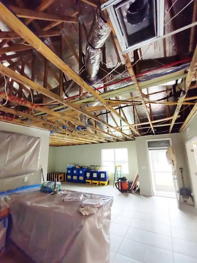 Opened ceiling with containment plastic and drying equipment during water damage restoration in Woodland Hills