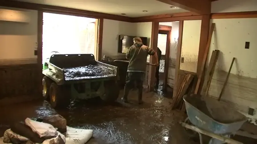 Mud and runoff inside a lower room of a hillside home after a winter storm near Woodland Hills