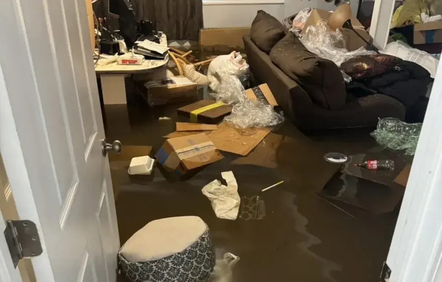 Flood water across a living room floor after a winter storm in Woodland Hills